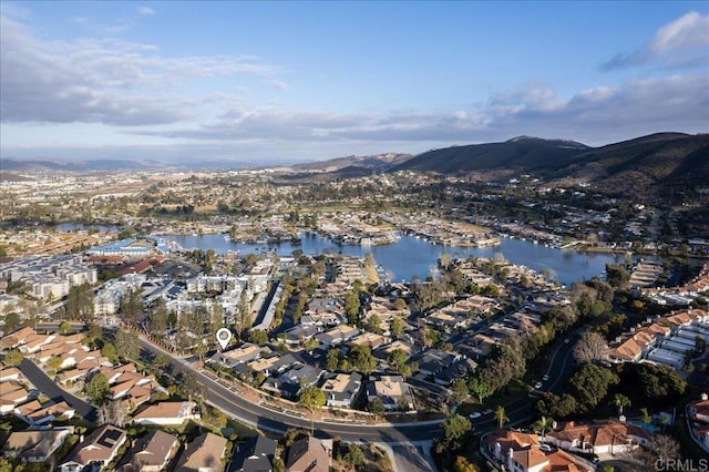 birds eye view of property with a water and mountain view