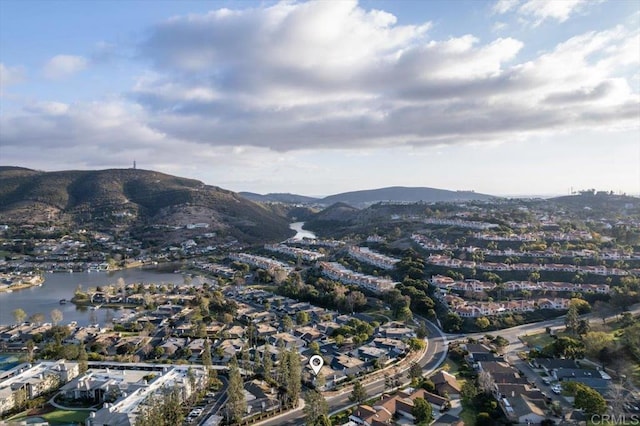 drone / aerial view featuring a water and mountain view