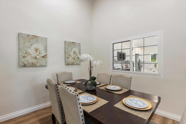 dining space featuring dark hardwood / wood-style floors