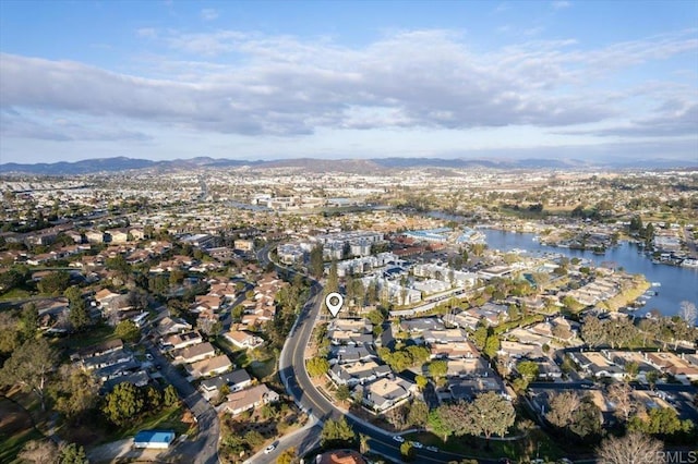 birds eye view of property with a water and mountain view