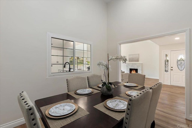 dining area featuring hardwood / wood-style floors and a high ceiling