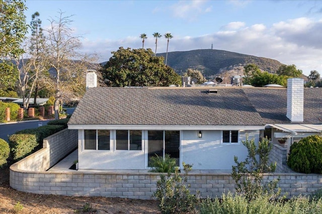 rear view of house featuring a mountain view