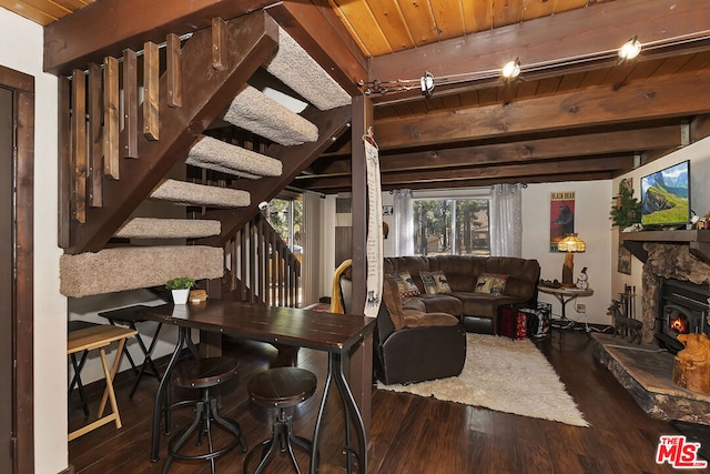 living room featuring beamed ceiling, wood ceiling, and dark hardwood / wood-style floors