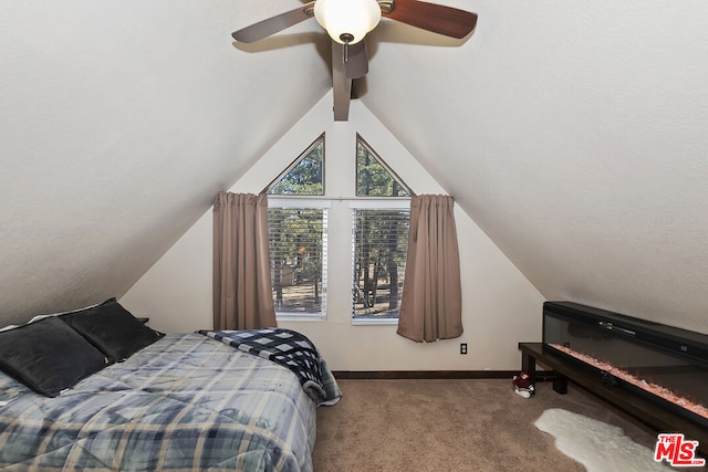 carpeted bedroom featuring lofted ceiling with beams and ceiling fan