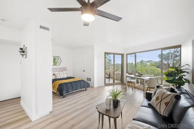 bedroom featuring access to exterior, ceiling fan, and light hardwood / wood-style flooring