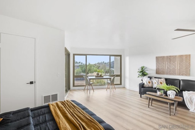 living room with ceiling fan and light wood-type flooring