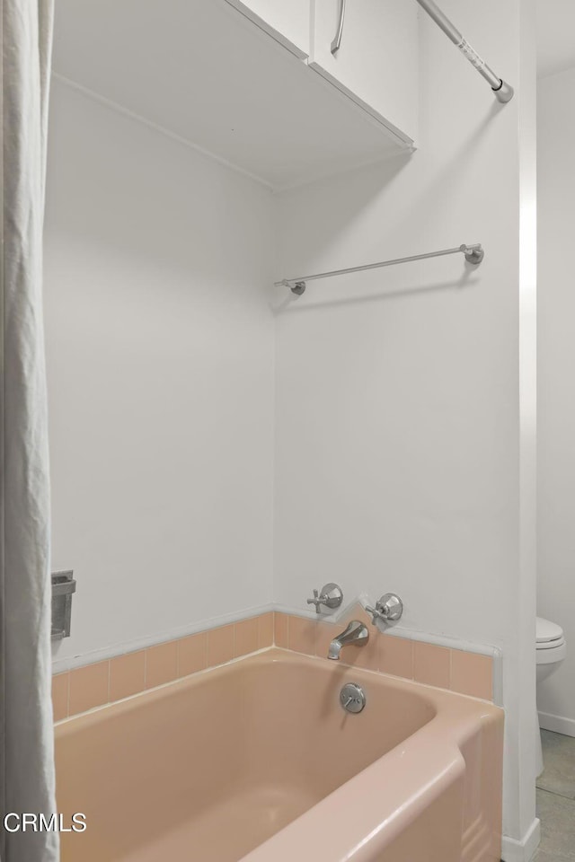 bathroom with toilet and a bathing tub