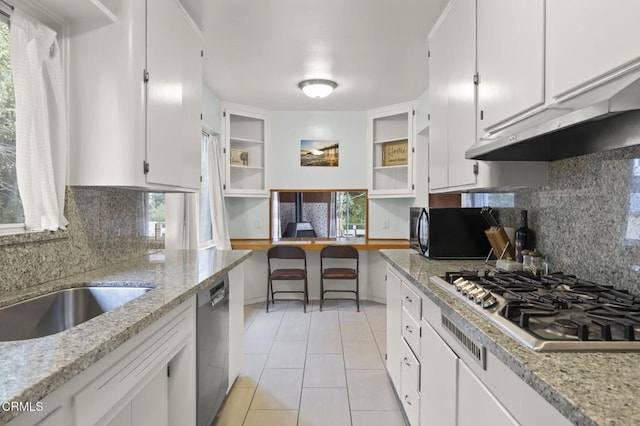 kitchen with dishwasher, light stone countertops, stainless steel gas cooktop, and white cabinets