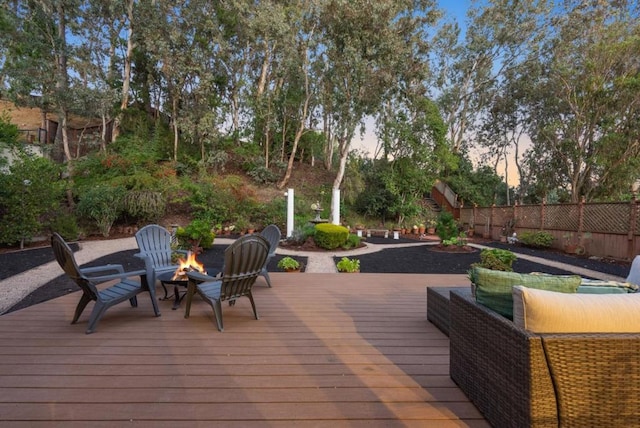 deck at dusk with an outdoor fire pit