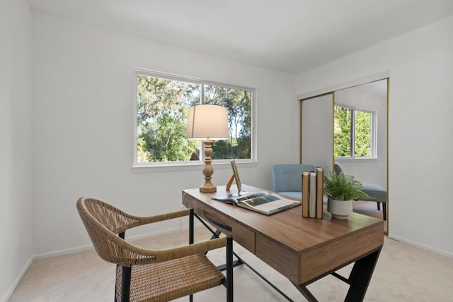 office area with plenty of natural light and light colored carpet