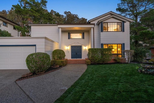 view of front facade with a garage and a lawn