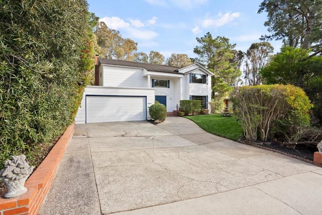 view of front of home with a garage and a front yard