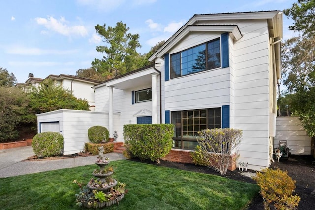 view of front of property featuring a garage and a front lawn