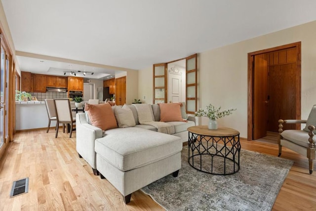 living room with light hardwood / wood-style floors