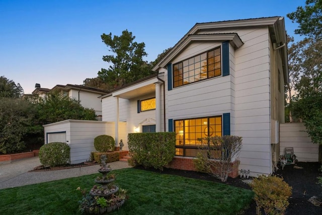 view of front of property featuring a yard and a garage