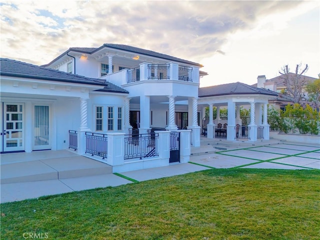 rear view of property with a yard, a patio area, and a gazebo