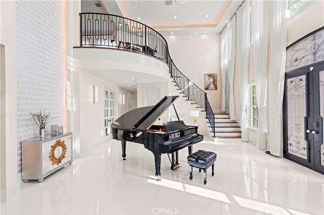 misc room featuring a towering ceiling and french doors