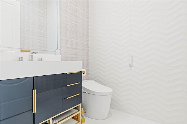 bathroom featuring vanity, tile walls, and toilet