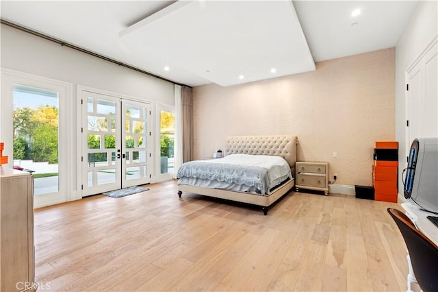 bedroom with access to exterior, multiple windows, and light wood-type flooring