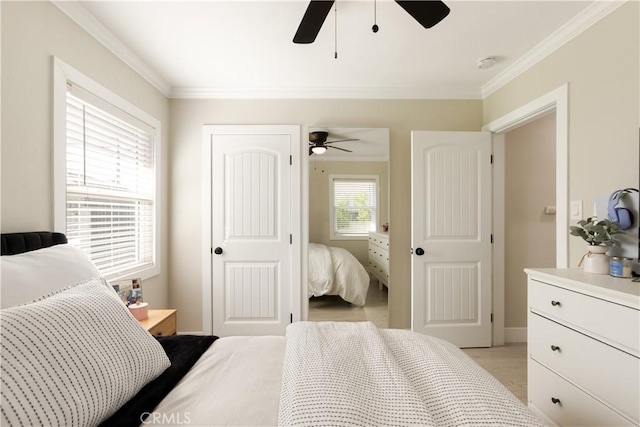 bedroom featuring crown molding, ceiling fan, and light hardwood / wood-style flooring