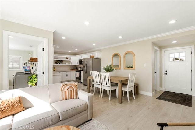 living room featuring ornamental molding and light hardwood / wood-style floors