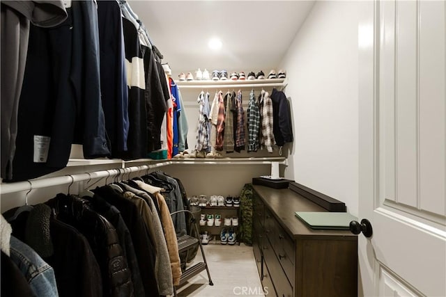 spacious closet with light hardwood / wood-style flooring