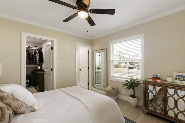 bedroom featuring crown molding, ceiling fan, and light hardwood / wood-style flooring