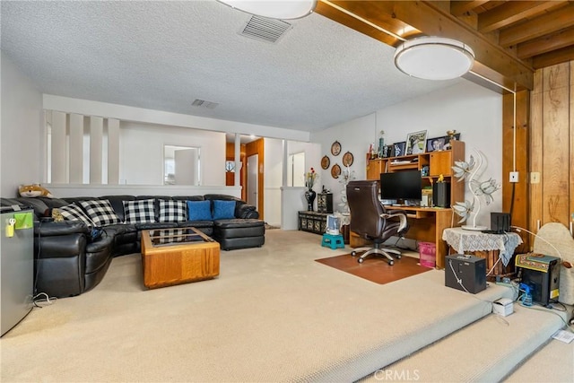 carpeted office featuring a textured ceiling