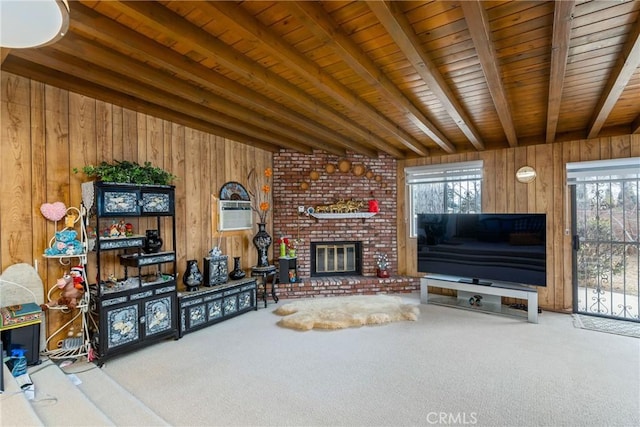 unfurnished living room featuring beamed ceiling, a wealth of natural light, carpet floors, and wood walls