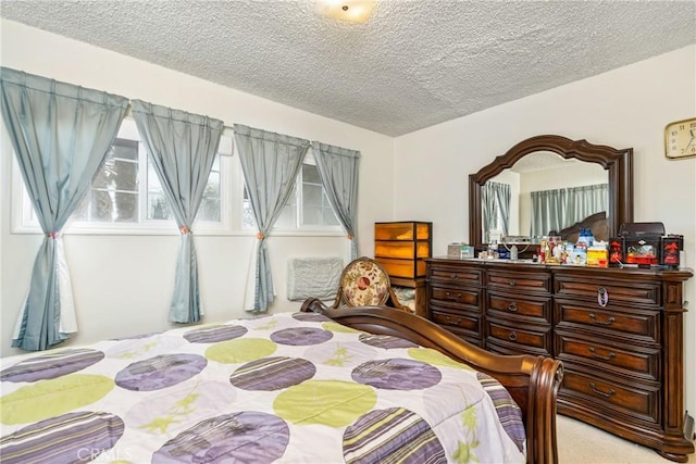 carpeted bedroom featuring a textured ceiling