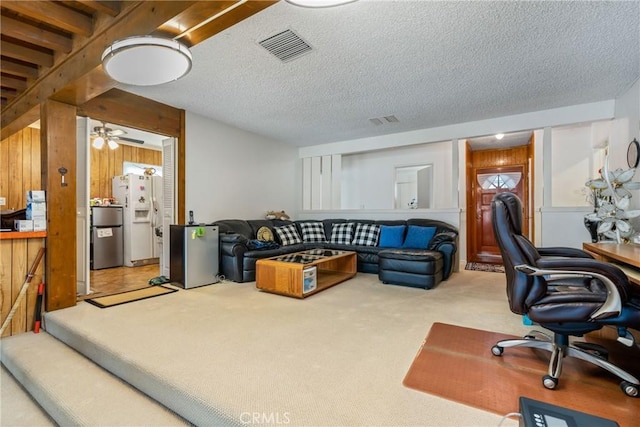 living room featuring light carpet and a textured ceiling