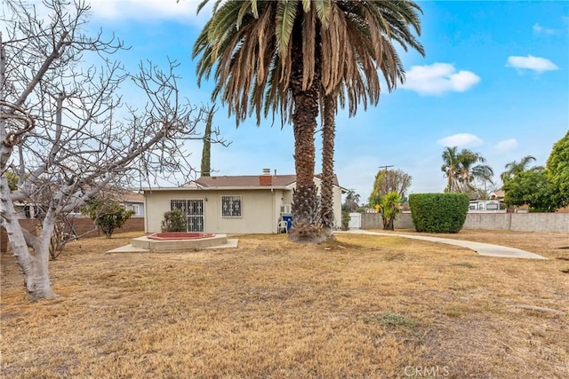 back of property featuring a lawn