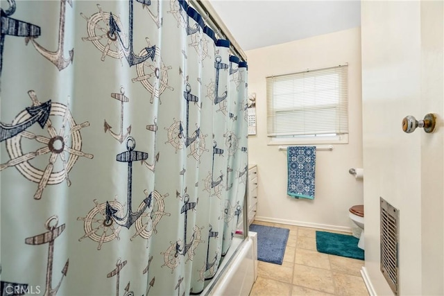 bathroom with tile patterned flooring, shower / bathtub combination with curtain, and toilet