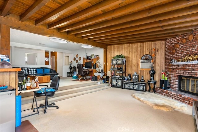 misc room featuring wooden walls, beamed ceiling, carpet flooring, a brick fireplace, and wooden ceiling