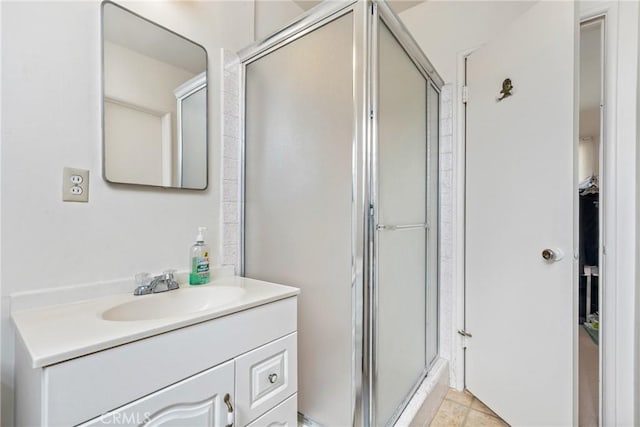 bathroom with vanity and a shower with door