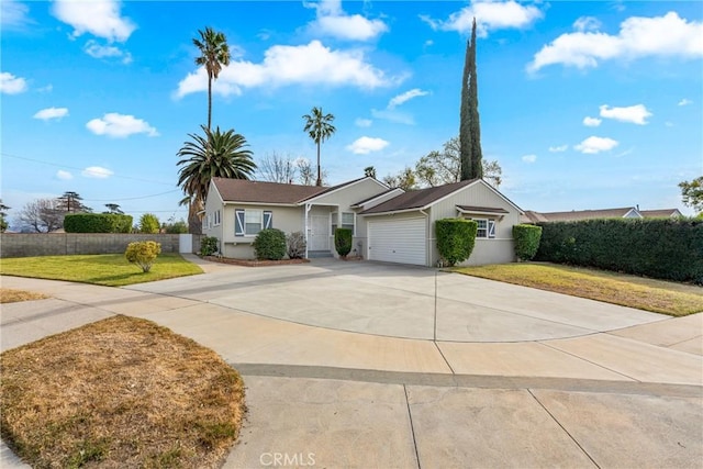 single story home featuring a garage and a front yard