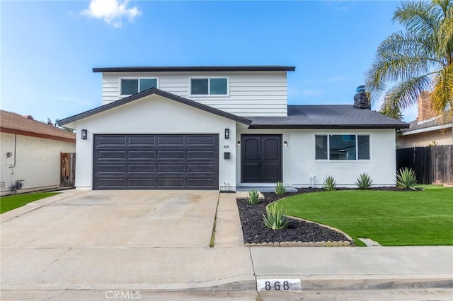 view of property with a garage and a front yard