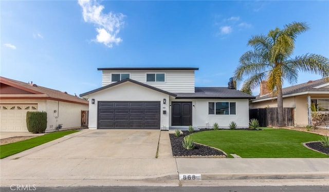 front of property with a garage and a front yard