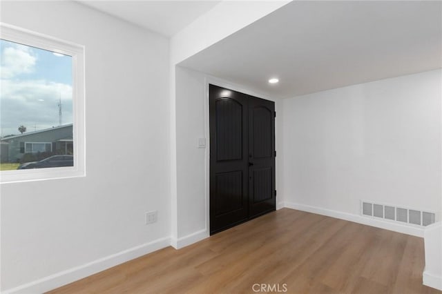 unfurnished room with light wood-type flooring