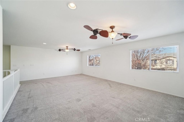 empty room with carpet floors and ceiling fan