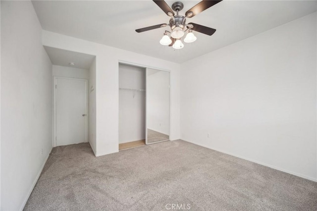 unfurnished bedroom with light carpet, ceiling fan, and a closet