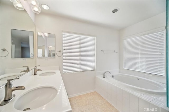 bathroom with vanity, tiled bath, tile patterned flooring, and a wealth of natural light