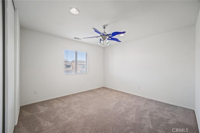 carpeted empty room featuring ceiling fan