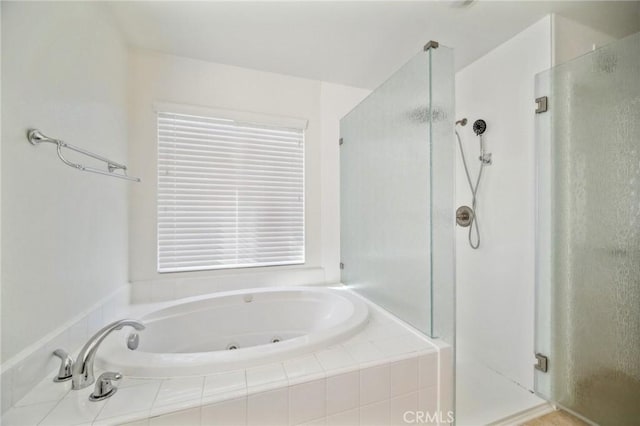 bathroom featuring independent shower and bath