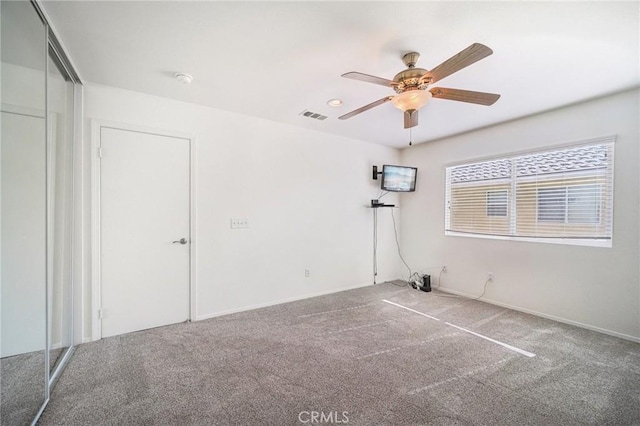 unfurnished room featuring carpet and ceiling fan