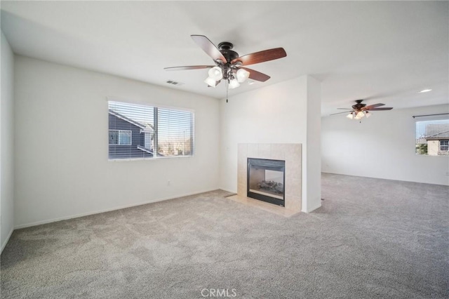 unfurnished living room with a fireplace and light colored carpet