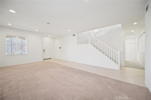 unfurnished living room featuring light carpet