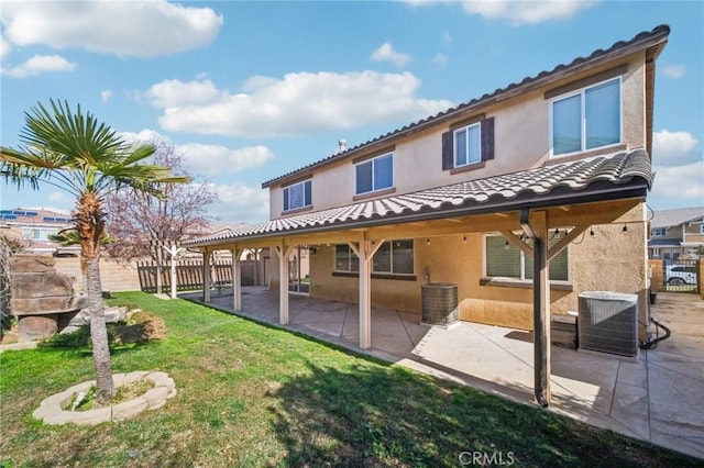 rear view of property featuring central AC, a yard, and a patio