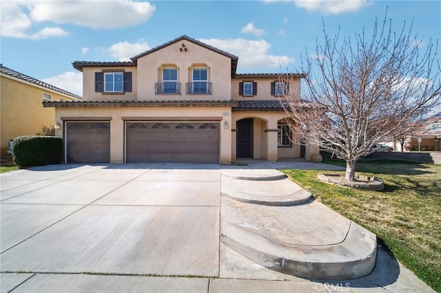 mediterranean / spanish-style house with a garage and a front yard