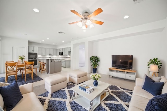 living room with sink and ceiling fan